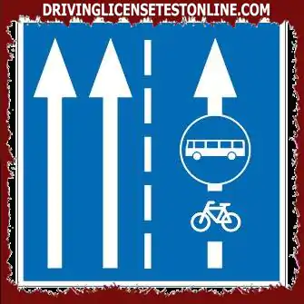 Can a person riding a two-wheeled bicycle travel in the traffic lane marked with a sign ?