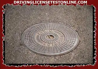 A manhole cover can be an added hazard when riding a motorcycle?
