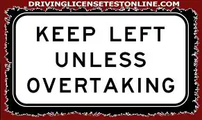 You are driving along a two-lane road at 60 km/h. You see a 'Keep Left Unless Overtaking' sign....