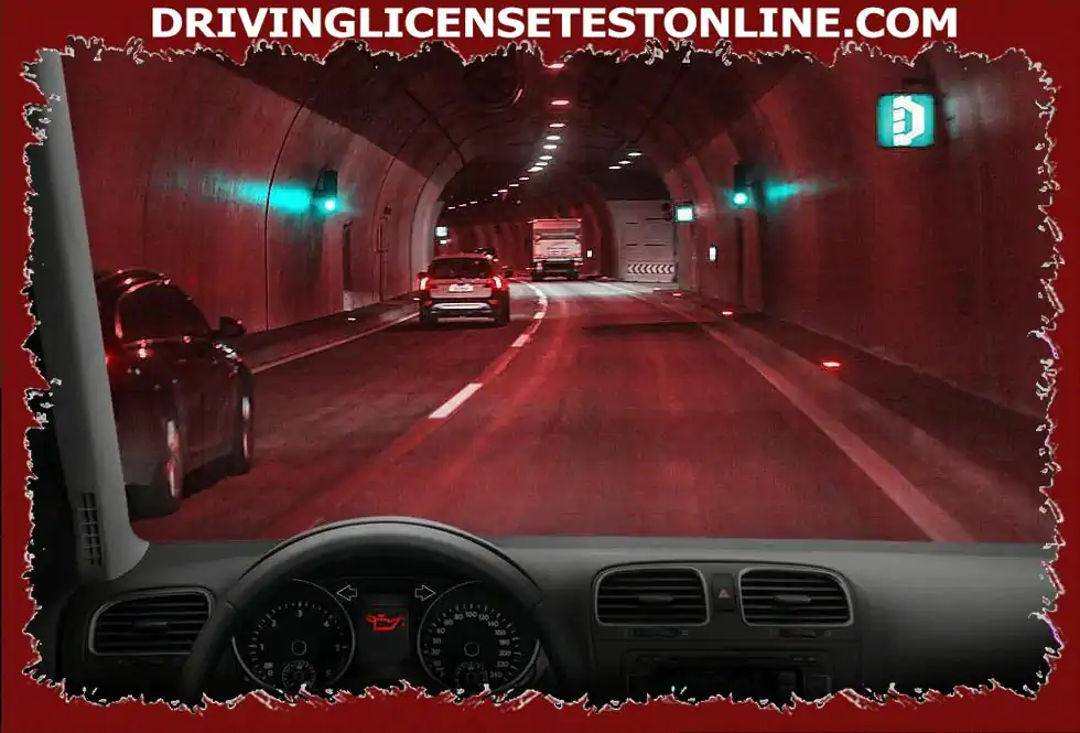 You are driving in this tunnel at 80 km / h . Suddenly this control lamp lights up . How will you behave ?