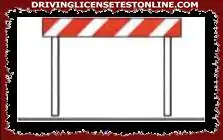 The barriers of the type in the figure prohibit parking along the edges of the roads where they are placed