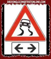 The sign shown indicates the continuation of the slippery stretch of road