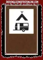 The sign shown indicates a camping area with tents and parking for caravans and motorhomes