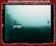 Because the fog is very dense, the vehicle seen in the photograph has the low beam and front...