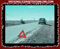 On this two-way out-of-town road, the driver of the vehicle seen in the photograph has placed...