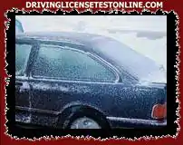 The windows of your vehicle are covered with ice . Before starting off, what should you do ?
