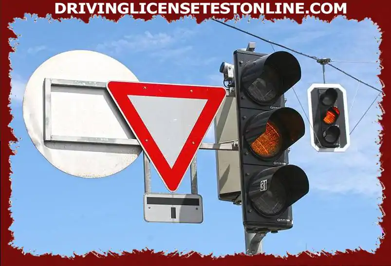How do you behave if the traffic light flashes yellow at an intersection ?