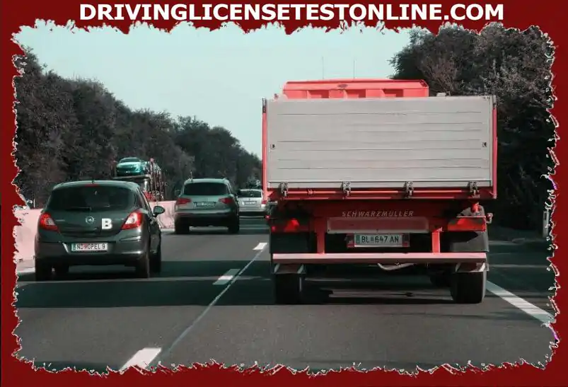 You are driving your vehicle combination on this motorway . The traffic on both lanes suddenly comes to a standstill . How do you behave in this situation ?