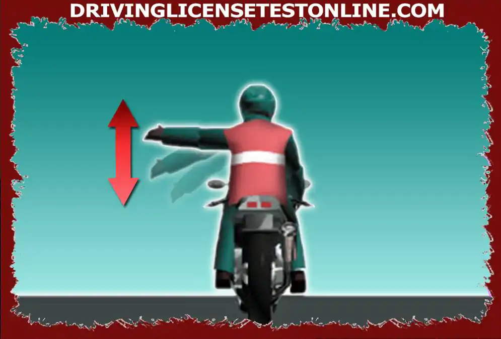 Co wskazuje kierowca motoroweru na zdjęciu ?