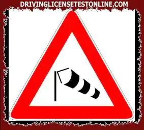In the event of a strong crosswind, the pictured sign | indicates a lesser danger for vehicles...