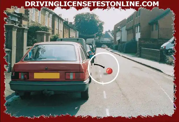 You are driving past a line of parked cars. What should you do if you notice a ball bouncing on...