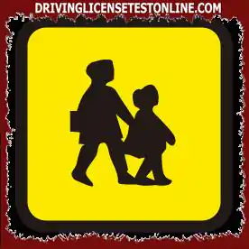 You are driving a bus displaying this sign. When can you use hazard warning lights ?